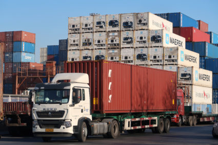 A worker drives a truck carrying a container at a logistics center near Tianjin port, in Tianjin, China December 12, 2019. Picture taken December 12, 2019. REUTERS/Yilei Sun