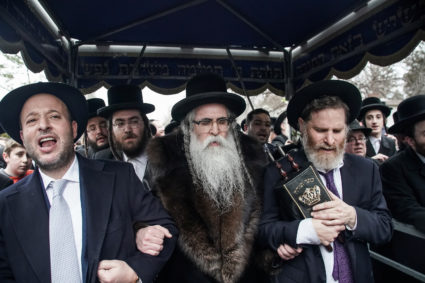 Rabbi Chaim Rottenberg celebrates with people the arrival of a new Torah at his residence in Monsey, New York, U.S., December 29, 2019. REUTERS/Jeenah Moon