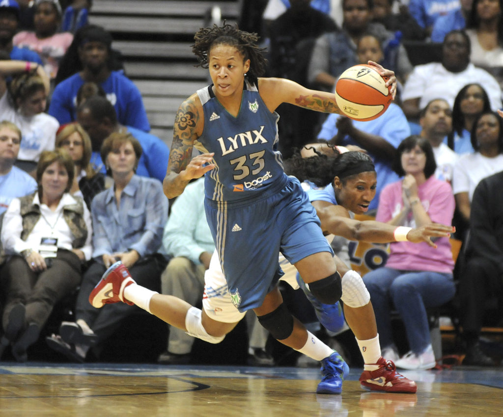 FILE PHOTO: Atlanta Dream guard Angel McCoughtry (rear) lunges but misses Minnesota Lynx guard Seimone Augustus (front) in...