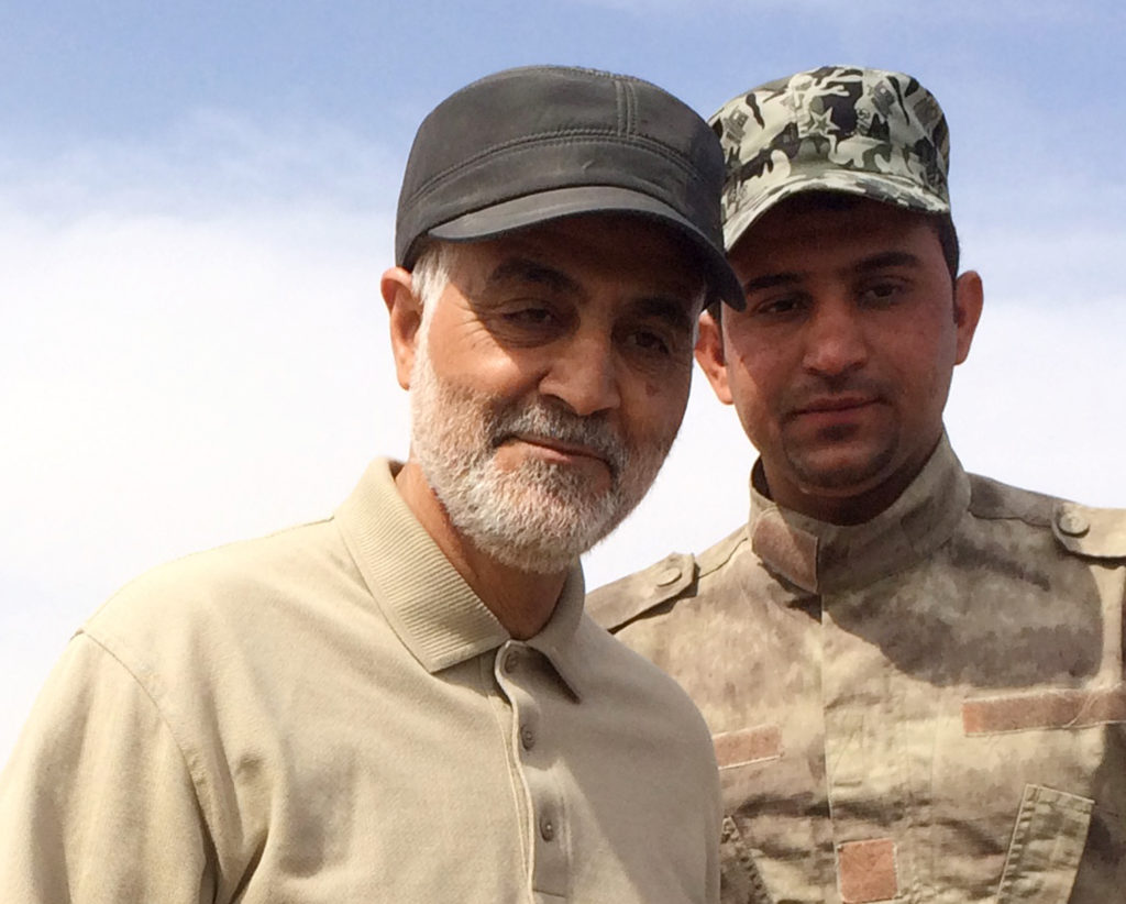 Iranian Revolutionary Guard Commander Qassem Soleimani (left) stands at the frontline during offensive operations against ...
