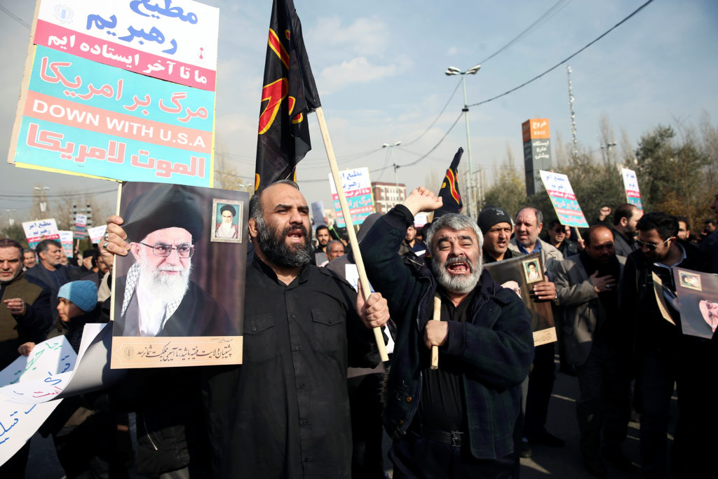 Demonstrators react during a protest against the assassination of the Iranian Major-General Qassem Soleimani, head of the ...
