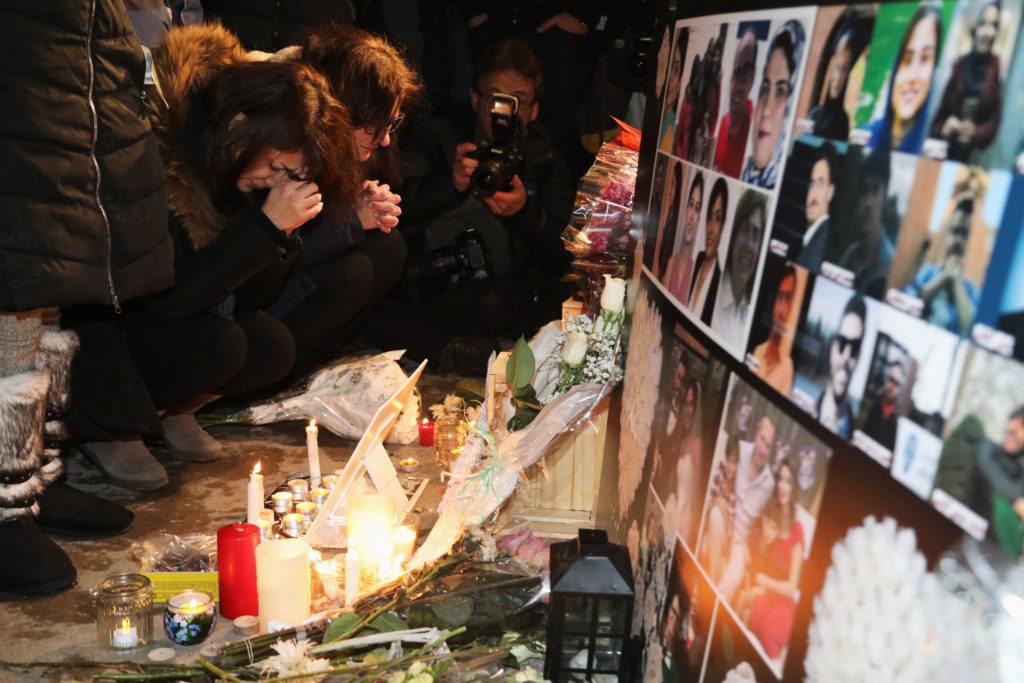 Mourners attend an outdoor vigil for the victims of a Ukrainian passenger jet which crashed in Iran, in Toronto, Ontario, ...