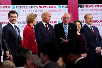 Democratic U.S. presidential candidates South Bend Mayor Pete Buttigieg, Senator Elizabeth Warren, former Vice President Joe Biden, Senator Bernie Sanders, Senator Amy Klobuchar and billionaire activist Tom Steyer stand onstage before the start of the sixth Democratic presidential candidates campaign debate at Loyola Marymount University in Los Angeles, California, U.S., December 19, 2019. Photo by Mike Blake/Reuters