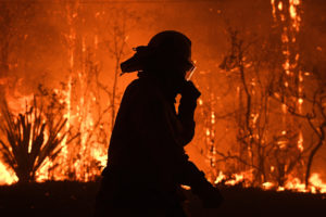 NSW Rural Fire Service crews protect properties on Waratah Road and Kelyknack Road as the Three Mile fire approaches Mangrove Mountain, Australia, December 5, 2019. Picture taken December 5, 2019. AAP Image/Dan Himbrechts/via REUTERS ATTENTION EDITORS - THIS IMAGE WAS PROVIDED BY A THIRD PARTY. NO RESALES. NO ARCHIVE. AUSTRALIA OUT. NEW ZEALAND OUT. NO COMMERCIAL OR EDITORIAL SALES IN NEW ZEALAND. NO COMMERCIAL OR EDITORIAL SALES IN AUSTRALIA. - RC2APD91BFHH