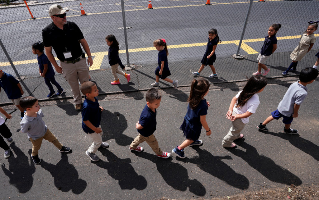 Joe Emery, TAC*ONE trainer and former Las Vegas police department sergeant, leads kindergarten students in evacuation trai...