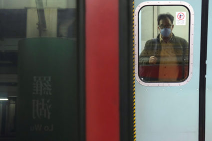 A passenger wears a face mask as he prepares to board a Hong Kong bound train at Lo Wu MTR station before the closing of the Lo Wu border, following the coronavirus outbreak in Hong Kong, China February 3, 2020. Photo by Tyrone Siu/Reuters