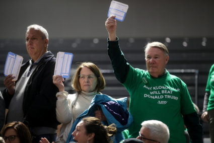 A supporter of Democratic presidential candidate Senator Amy Klobuchar holds up a piece of paper during a caucus in Des Moines, Iowa, U.S., February 3, 2020. Photo by Jonathan Ernst/Reuters