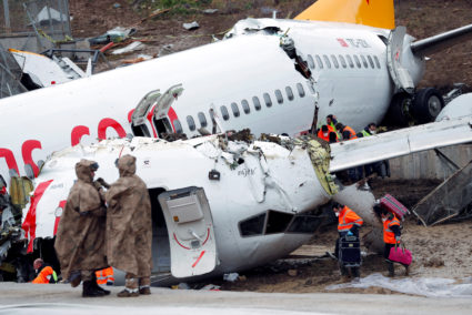 People work at the Pegasus Airlines Boeing 737-86J plane wreckage, after it overran the runway during landing and crashed, at Istanbul's Sabiha Gokcen airport, Turkey February 6, 2020. Photo by Murad Sezer/Reuters