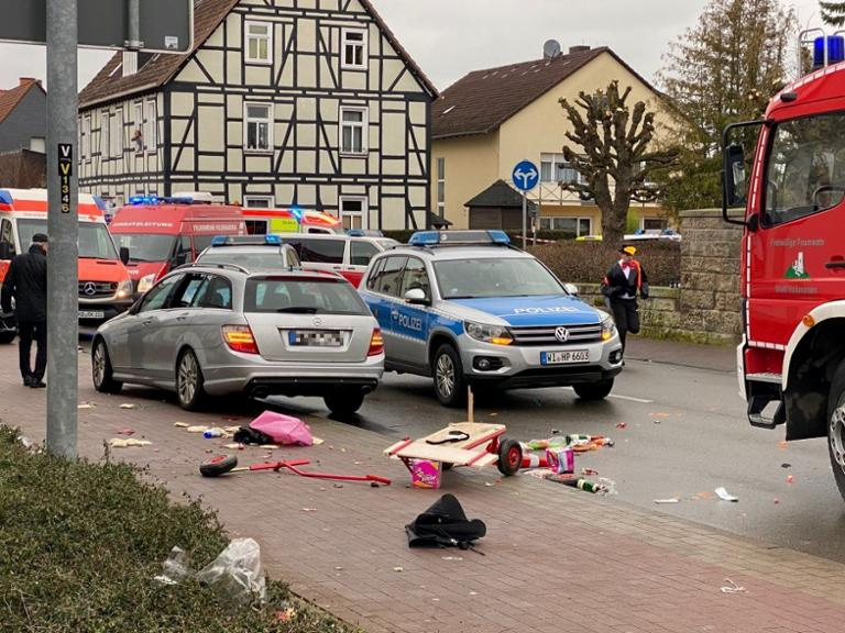People react at the scene after a car ploughed into a carnival parade injuring several people in Volkmarsen, Germany Febru...