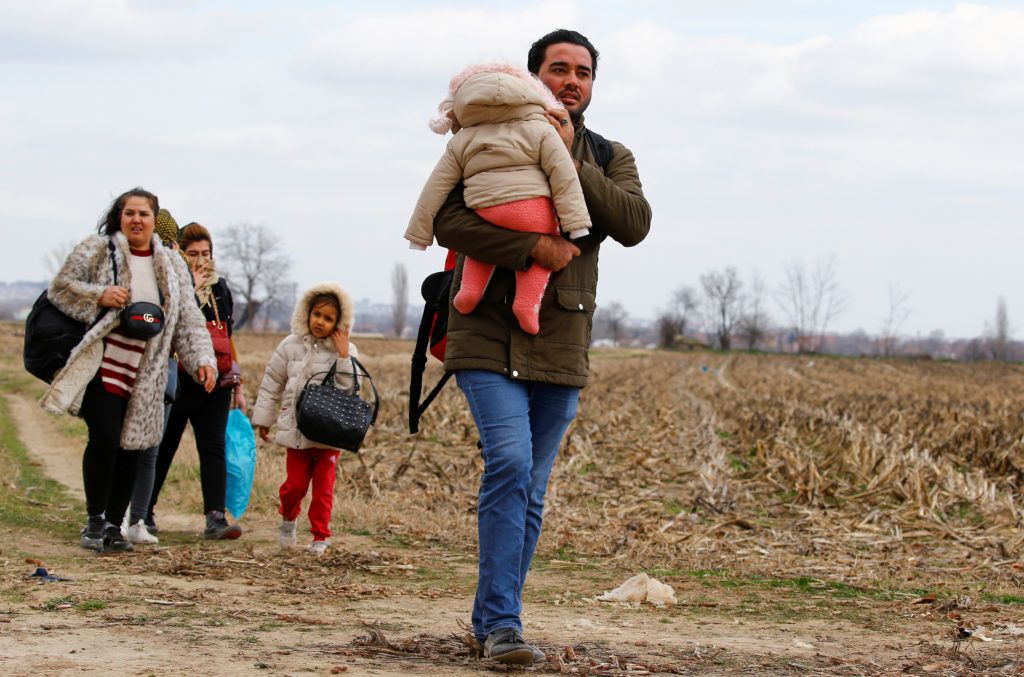 Migrants walk to the Turkey's Pazarkule border crossing with Greece's Kastanies, in Pazarkule, Turkey, February 28, 2020. ...