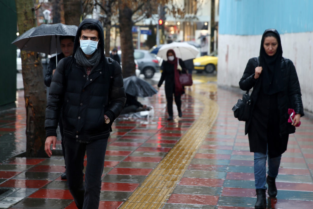 An Iranian man wears protective mask to prevent contracting coronavirus, as he walks in the street in Tehran, Iran Februar...