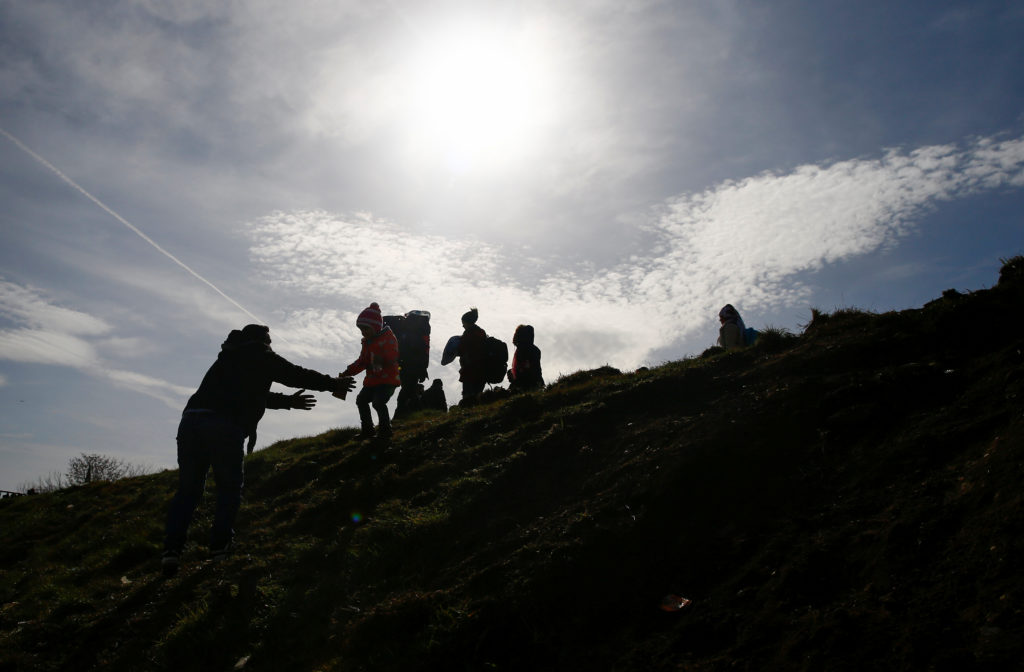 Migrants walk, near the Turkey's Pazarkule border crossing with Greece's Kastanies, near Edirne, Turkey, March 3, 2020. Ph...