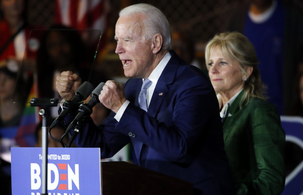 Democratic U.S. presidential candidate and former Vice President Joe Biden addresses supporters as his wife Jill looks on ...