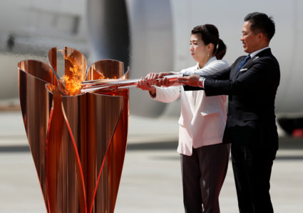 Olympic flame lands in Japan as doubts grow over Tokyo Games