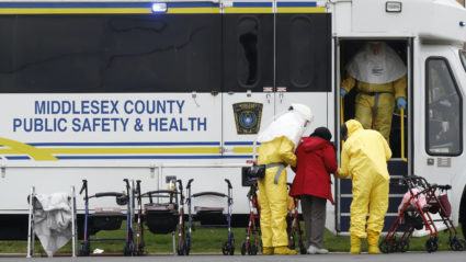 Medical officials aid a residents from St. Joseph's nursing home to board a bus, after a number of residents tested positive for coronavirus disease (COVID-19) in Woodbridge, New Jersey, U.S., March 25, 2020.