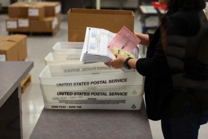 Eliza Luna, a ballot designer with the Maricopa County Elections Department, counts ballots for the Arizona Presidential Preference Election at the Maricopa County Tabulation and Election Center in Phoenix, Arizona, U.S., March 17, 2020. REUTERS/Cheney Orr - RC2ZLF9MH5QR