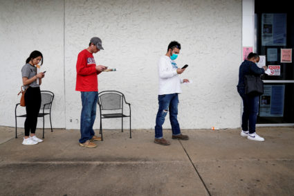 FILE PHOTO: People who lost their jobs wait in line to file for unemployment following an outbreak of the coronavirus disease (COVID-19), at an Arkansas Workforce Center in Fayetteville, Arkansas, U.S. April 6, 2020. Photo by REUTERS/Nick Oxford/File Photo