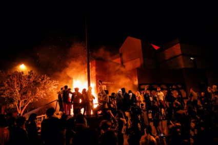 Protesters gather around after setting fire to the entrance of a police station as demonstrations continue after a white police officer was caught on a bystander's video pressing his knee into the neck of African-American man George Floyd, who later died at a hospital, in Minneapolis, Minnesota, U.S., May 28, 2020. Photo by Carlos Barria/REUTERS