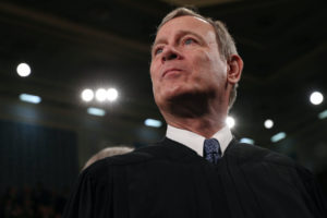 FILE PHOTO: U.S. Supreme Court Chief Justice John Roberts waits for U.S. President Donald Trump's State of the Union address to a joint session of the U.S. Congress in the House Chamber of the U.S. Capitol in Washington, U.S. February 4, 2020. Photo by Leah Millis/POOL/Reuters