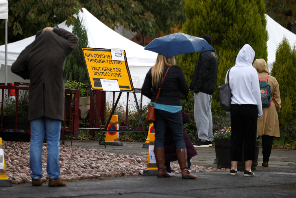 People stand in a queue to get tested for COVID-19 at a walk-through centre amid the coronavirus disease (COVID-19) outbre...