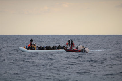 FILE PHOTO: Migrants wearing lifejackets on a rubber dinghy are pictured during a rescue operation by the MSF-SOS Mediterranee run Ocean Viking rescue ship, off the coast of Libya in the Mediterranean Sea, February 18, 2020. Picture taken February 18, 2020. Photo by Hannah Wallace Bowman/MSF/Handout via REUTERS