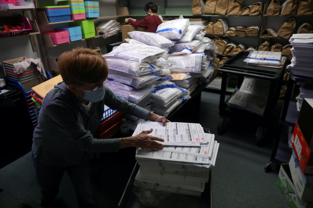 The election official Pam Hainault works in the ballot room organizing unused ballots returned from voting precincts after...