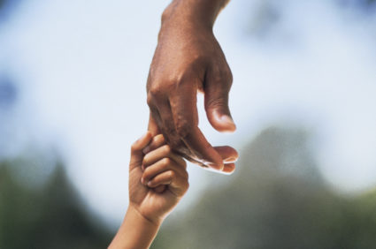 Child holding adult's hand