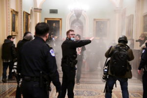 Supporters of President Donald Trump set off a fire extinguisher after breaching security defenses, as police move in on the demonstrate on the second floor of the U.S. Capitol near the entrance to the Senate, in Washington, D.C. Photo by Mike Theiler/Reuters