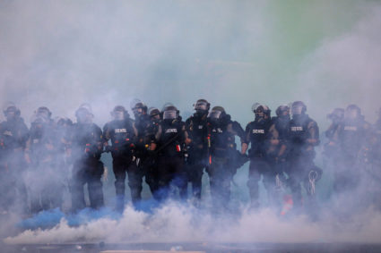 Police officers are seen amid tear gas as protesters continue to rally against the death in Minneapolis police custody of George Floyd, in Minneapolis, Minnesota, U.S. May 30, 2020. Photo by Leah Millis/Reuters.