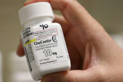 A pharmacist holds a bottle OxyContin made by Purdue Pharma at a pharmacy in Provo, Utah, U.S., May 9, 2019.