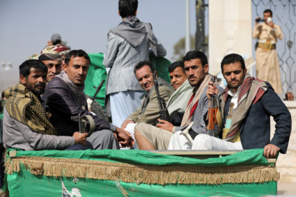 Armed Houthi followers ride on the back of a truck after participating in a funeral of Houthi fighters killed in recent fighting against government forces in Yemen's oil-rich province of Marib, in Sanaa, Yemen February 20, 2021. Photo by Reuters/Khaled Abdullah/File Photo