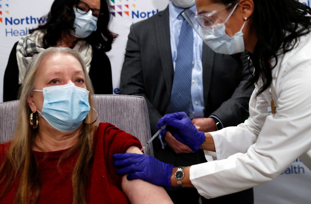 Jeanine Mucci, RN, administers the Johnson & Johnson's coronavirus disease (COVID-19) vaccine to Susan Maxwell-Trumble, 67...