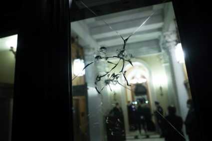 Riot damage to glass doors can be seen near the House floor during debate on a resolution demanding Vice President Pence and the cabinet remove President Trump from office, at the Capitol in Washington, U.S. January 12, 2021. Photo by Jonathan Ernst/Reuters.
