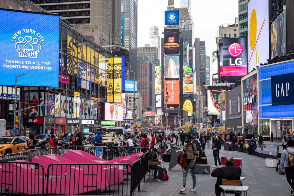 FILE PHOTO: People wearing protective masks are seen in Times Square during the outbreak of the coronavirus disease (COVID...