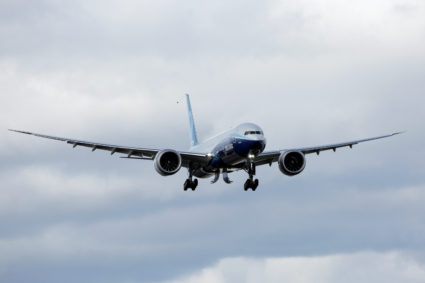 A Boeing 777X airplane flies above the Boeing Everett Factory after Boeing announced a temporary suspension of production operations at its Puget Sound area facilities, during the coronavirus disease (COVID-19) outbreak, in Everett, Washington, U.S. March 23, 2020. REUTERS/David Ryder