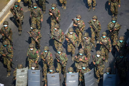 Myanmar soldiers walk along a street during a protest against the military coup in Yangon, Myanmar, February 28, 2021. Photo by Stringer/REUTERS