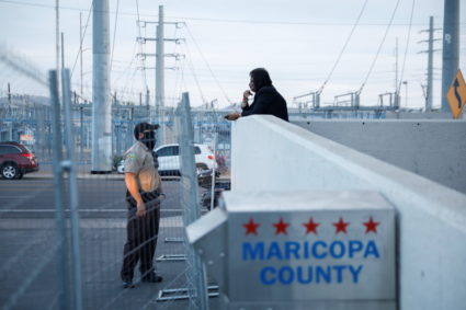 An employee of the Maricopa County Tabulation and Election Center (MCTEC) speaks to a police officer in Phoenix, Arizona November 5, 2020. Photo by Cheney Orr/REUTERS