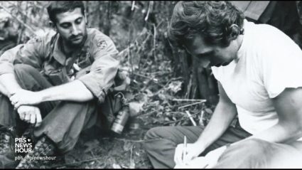 Journalist Peter Osnos reporting on location in a black and white photo