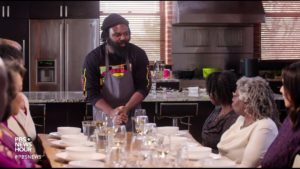 A group of people gather around a dinner table for a meal in the new documentary, 'High on the Hog'