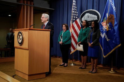 Attorney General Merrick Garland announces investigation into Georgia voting laws at a podium.