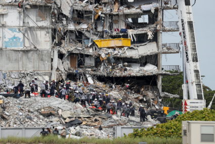 Emergency workers conduct search and rescue efforts at the site of a partially collapsed residential building in Surfside