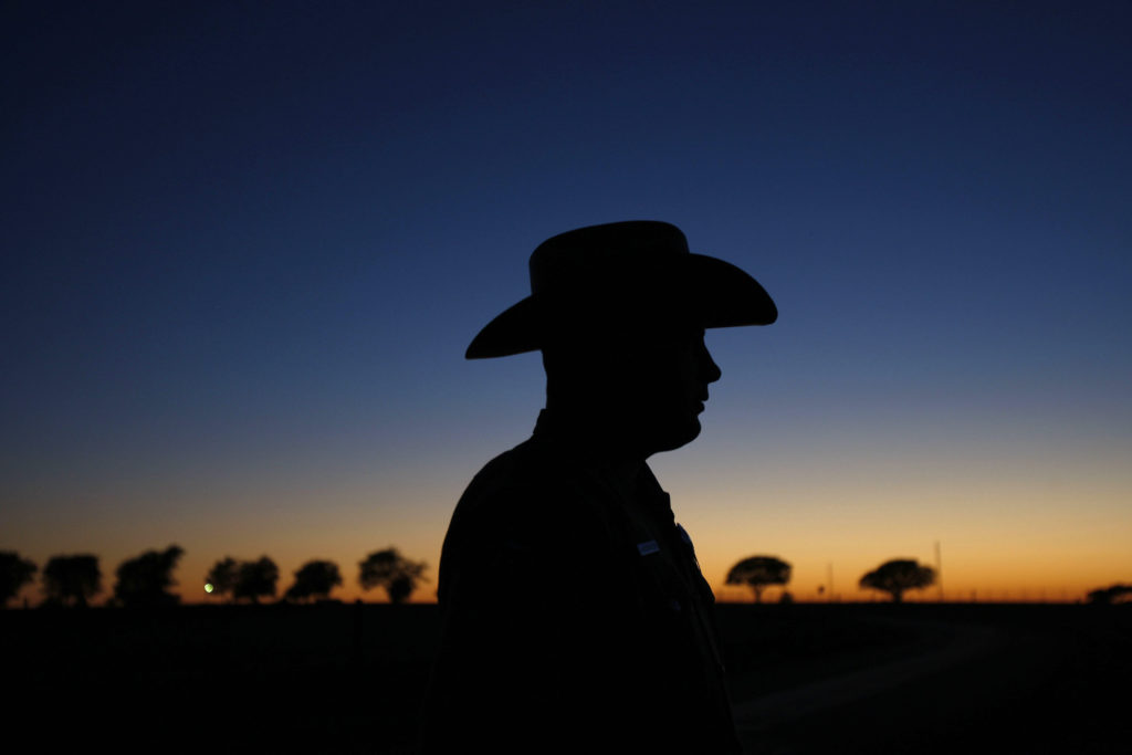 Texas state trooper waits to escort U.S. President Bush in a motorcade in Texas