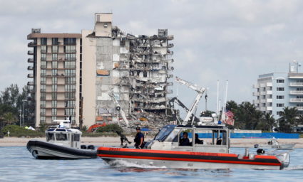 U.S. Coast Guard and Miami-Dade Police patrol as U.S. President Joe Biden visits the area while rescue efforts are halted ...