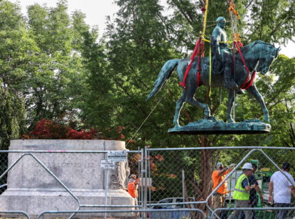 Workers remove a statue of Confederate General Robert E. Lee, in Charlottesville
