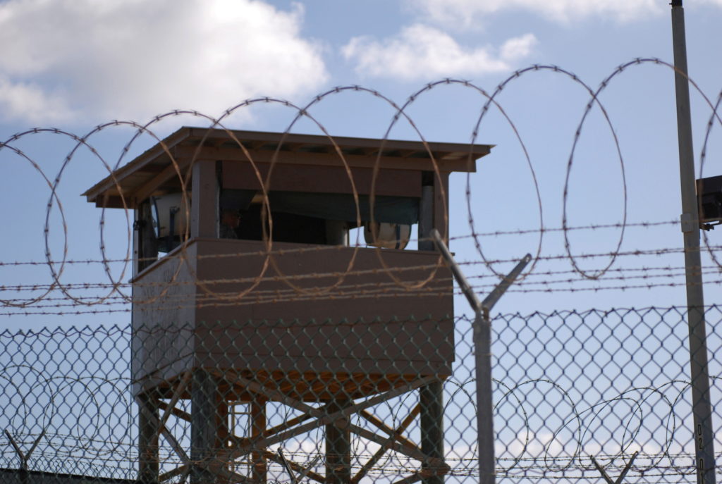 FILE PHOTO: FILE PHOTO: File photo of a soldier standing guard in a tower overlooking Camp Delta at Guantanamo Bay naval base