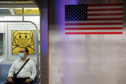 A commuter wears a mask while riding the subway as cases of the infectious coronavirus Delta variant continue to rise in N...
