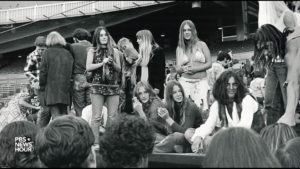 Young people sit around a circle in a black and white photograph