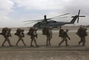 U.S. Marines prepare to depart upon the end of operations for Marines and British combat troops in Helmand