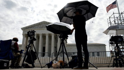 Television news photographers prepare to cover the final opinions of the current court’s term at the U.S. Supreme Court bu...