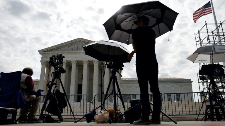 Television news photographers prepare to cover the final opinions of the current court’s term at the U.S. Supreme Court bu...